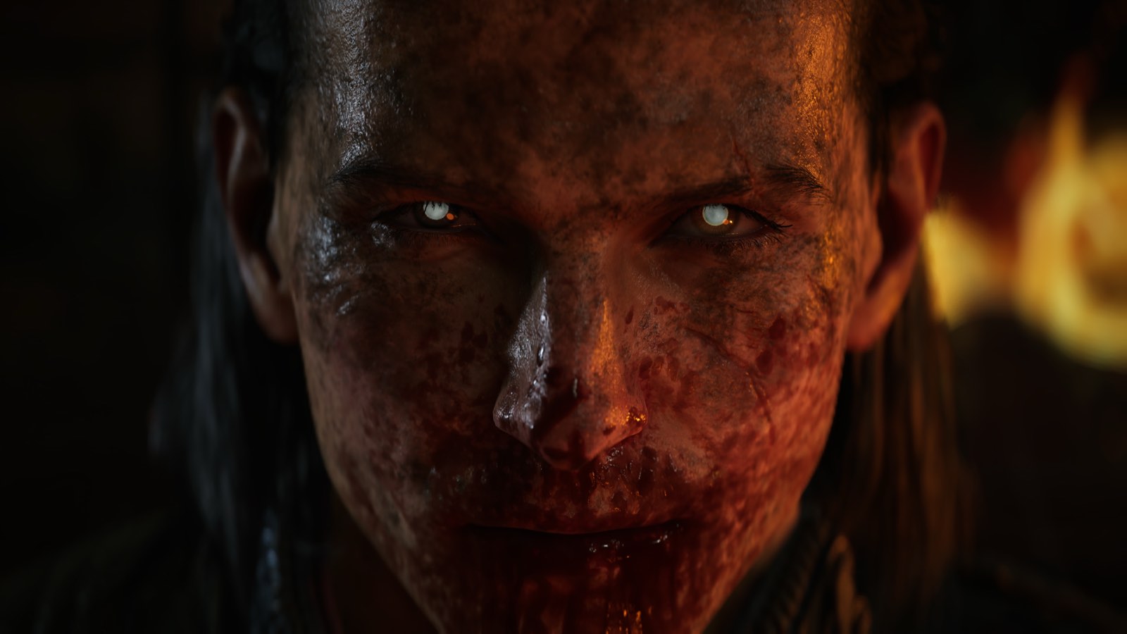 Close-up of a bloodied, corrupted face with pale eyes, from official footage